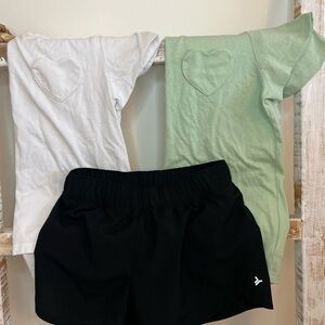 White and green heart shaped t-shirt with black shorts